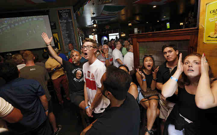 Fans react to a goal by France's Paul Pogba while watching the World Cup final against Croatia at Fado Irish Pub at Easton. France won the match 4-2.   (Adam Cairns / The Columbus Dispatch)